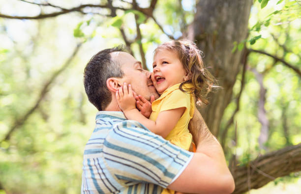 istock Father with his daughter having fun outside in forest 1408270646