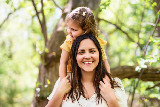 istock mother with his daughter having fun outside in forest 1408270647