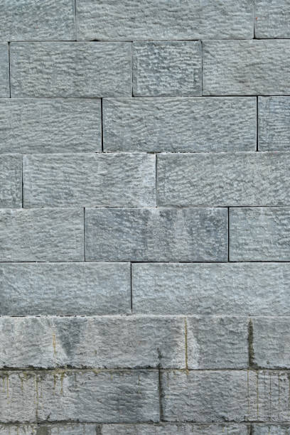 istock closeup the bunch grey brown stone wall soft focus natural grey brown background. 1408270650