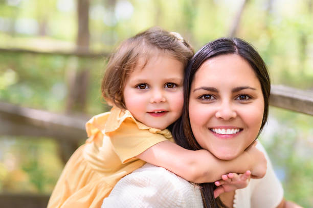 istock mother with his daughter having fun outside in forest 1408271551