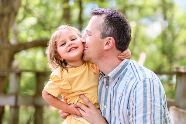 istock Father with his daughter having fun outside in forest 1408271615