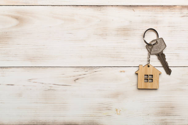 istock Keys with house-shaped keychain on wooden background 1408273286