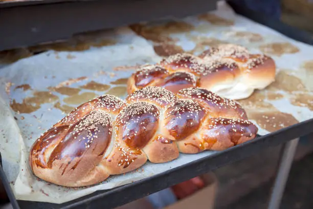 Freshly-baked loaves of challah bread with sesame seeds at Carmel Market, Tel Aviv
