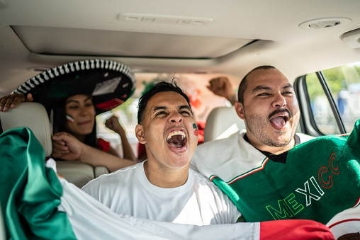 Mexican fans celebrating at car