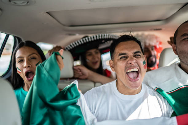 istock Mexican fans celebrating at car 1408276107