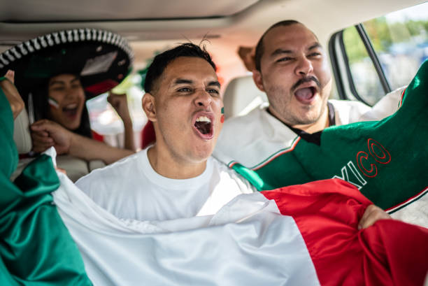 istock Mexican fans celebrating at car 1408276108