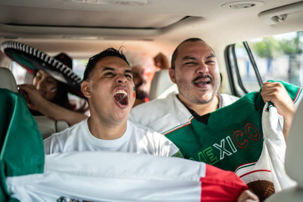 istock Mexican fans celebrating at car 1408276109