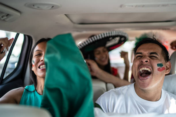 istock Mexican fans celebrating at car 1408276115