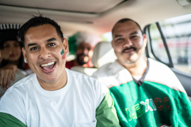 istock Mexican fans celebrating at car 1408276121