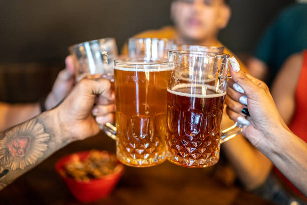 istock Friends toasting a beer at a bar 1408277448