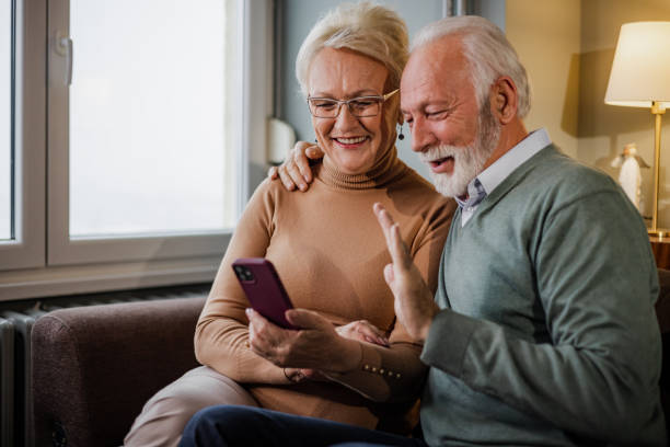 istock Cute senior couple using mobile phone 1408277762