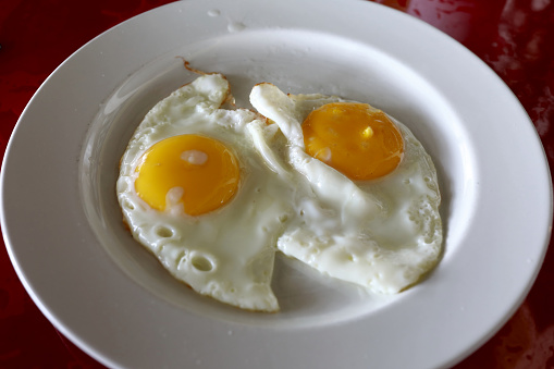 Toasted bread topped with half boiled eggs