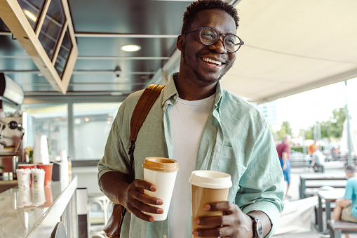 African-American student picking up a coffee