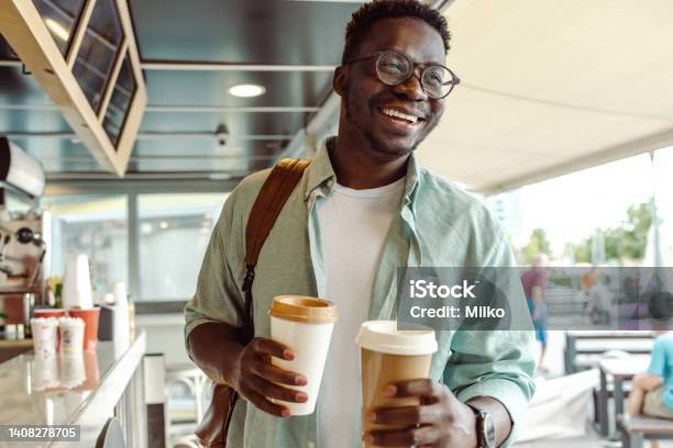Africanamerican Student Picking Up A Coffee Stock Photo - Download Image Now - Coffee - Drink, Coffee Shop, Morning