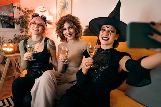 istock Three young women taking selfies at Halloween party 1408279097