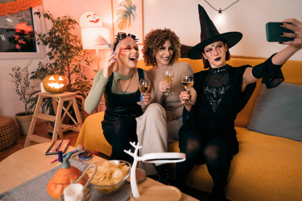 istock Three young women taking selfies at Halloween party 1408279135
