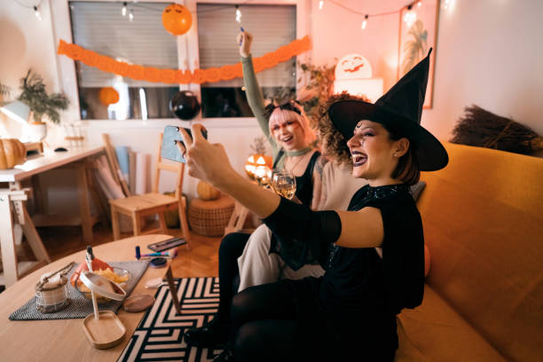 istock Three young women taking selfies at Halloween party 1408279173