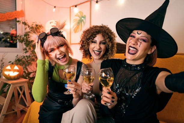 istock Three young women taking selfies at Halloween party 1408279177