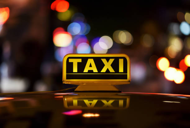 Moscow, Russia - November 11, 2022. Yandex Taxi is moving fast on urban road among skyscrapers. Blurred illumination of towers Moscow International Business Center.
