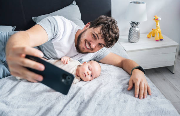 istock Father taking a selfie with his baby son using smartphone. 1408281702