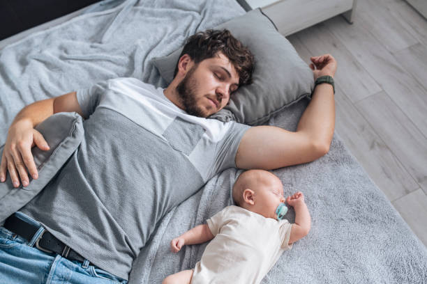 istock Father and baby boy sleeping. 1408281789