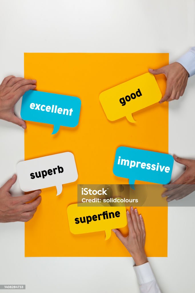 Customer Satisfaction Hands holding colorful speech bubbles on yellow background. Feedback Stock Photo