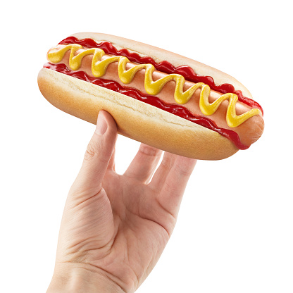 Delicious hot dog in male hand, isolated on white background