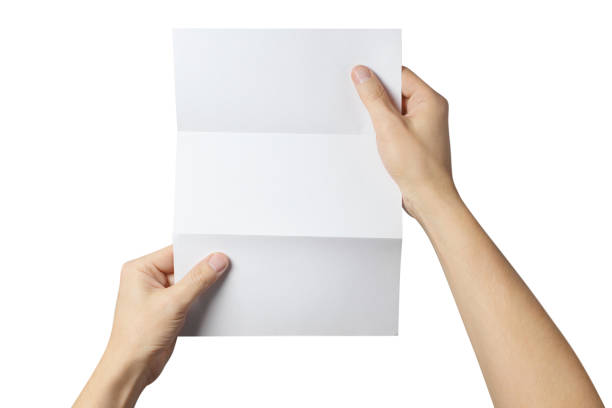 istock Hands holding a folded sheet of white paper on white 1408284964