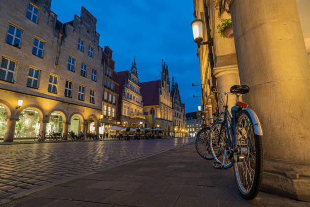 Bicycle City Münster - Bicycles at the Prinzipalmarkt Blue hour at the Prinzipalmarkt in the old town of Münster with bicycles in the foreground munster stock pictures, royalty-free photos & images