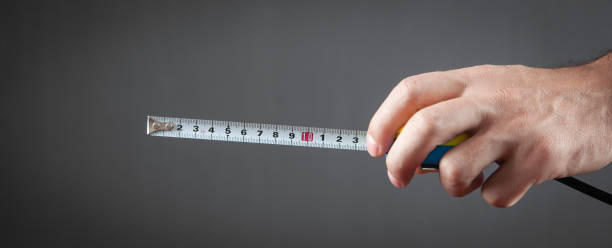 male hand holding measuring tape. - 13431 imagens e fotografias de stock