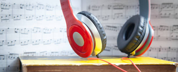 istock Headphones and book on music note. 1408285811