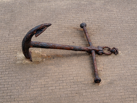 A rusty old anchor embedded in the promenade at Harwich in Essex, Eastern England.