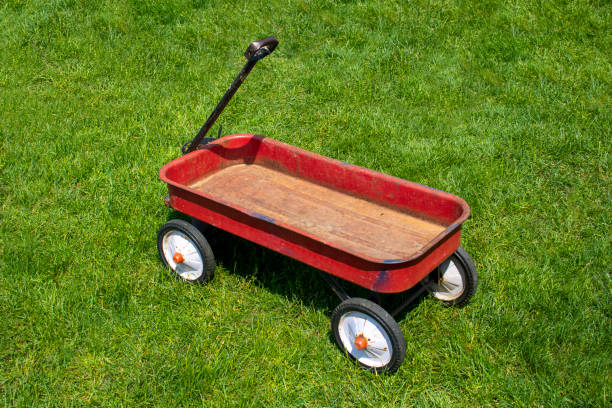 istock red white and black four wheeled child pull wagon outdoors in grassy backyard 1408289248