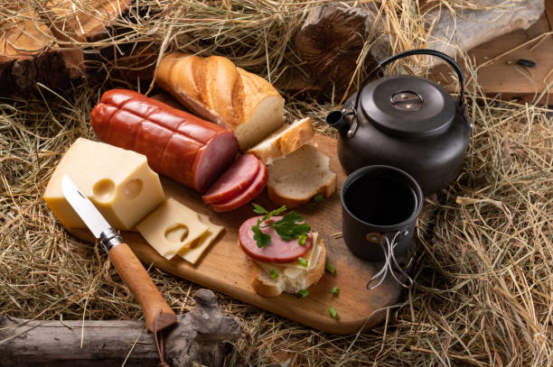 istock Sliced cheese and meat. Baguette sandwich with ham and cheese. Folding kitchen knife. 1408290036