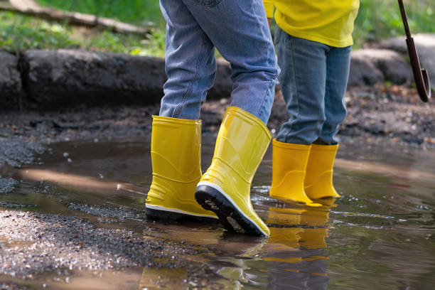 istock children walk through the puddles after the rain 1408291883