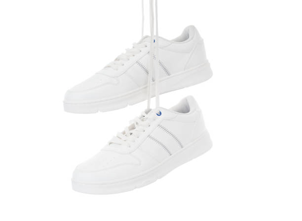 istock Pair modern sport sneakers close up isolated on white background 1408293180