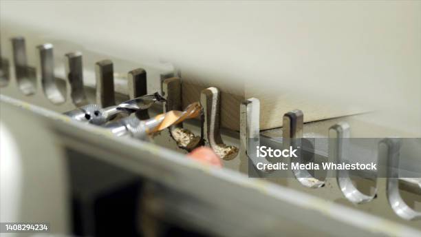 Closeup Of Machine With Drills For Drilling Wooden Boards Action Modern Automated Machine For Drilling Of Wooden Bars At Woodworking Industrial Enterprise Stock Photo - Download Image Now
