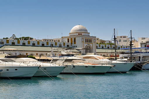 Rhodes, Greece - May 2022: Row of luxury motor yachts moored in the town's marina