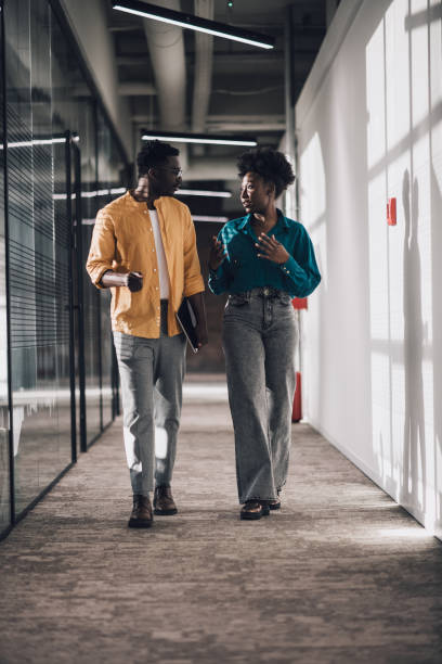 istock Black coworkers discussing a project at work 1408296288
