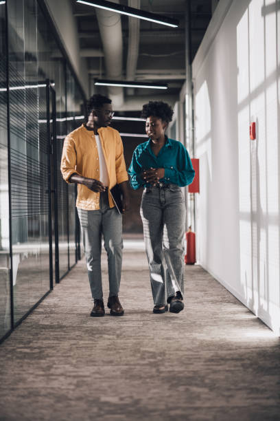 istock Colleagues taking a walk in their office building 1408296305