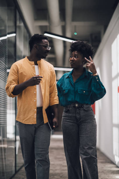 istock Young African-American business people talking at work 1408296329