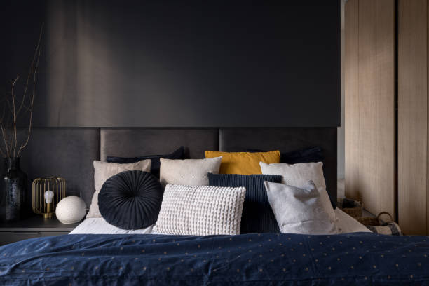 istock Stylish bed in modern dark bedroom 1408296734