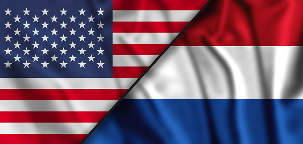 Netherlands and United States table flags isolated. 3D rendering. Waving flags of the USA and the Netherlands.