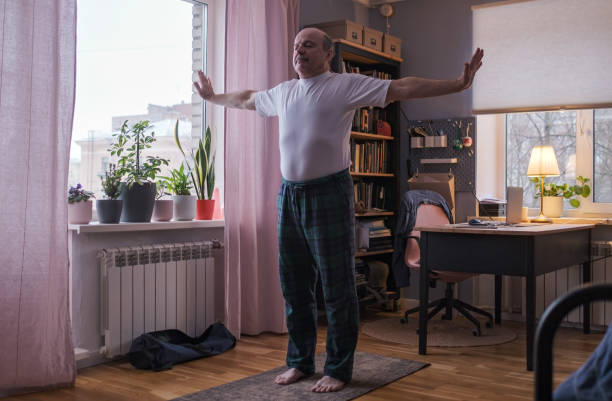 istock Senior man working out, yoga in basic standing asana tadasana, mountain posture 1408302978
