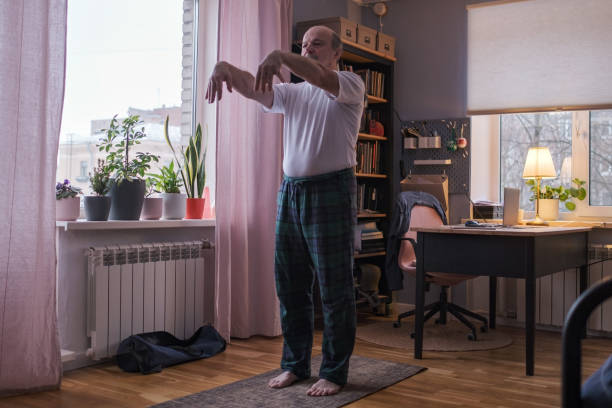 istock Senior man working out, yoga in basic standing asana tadasana, mountain posture 1408303009