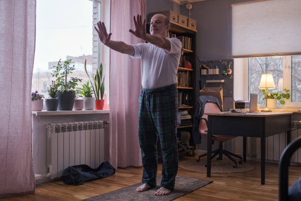 istock Senior man working out, yoga in basic standing asana tadasana, mountain posture 1408303015