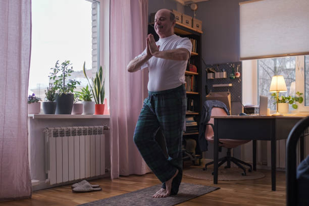 istock Senior man working out, yoga in basic standing asana tadasana, mountain posture 1408303020