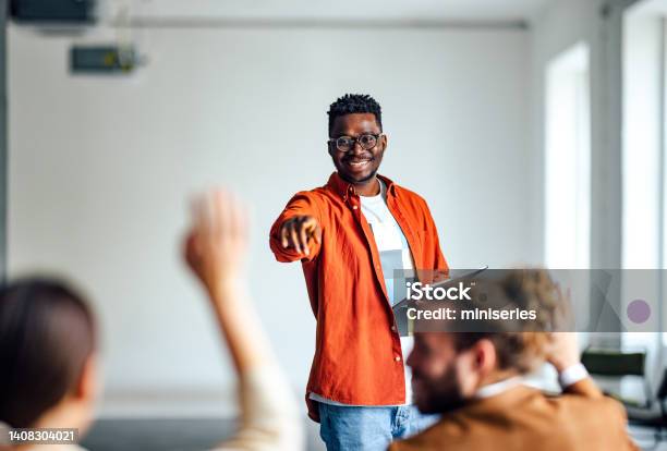 Cheerful Male Presenter Interacting With The Audience Stock Photo - Download Image Now