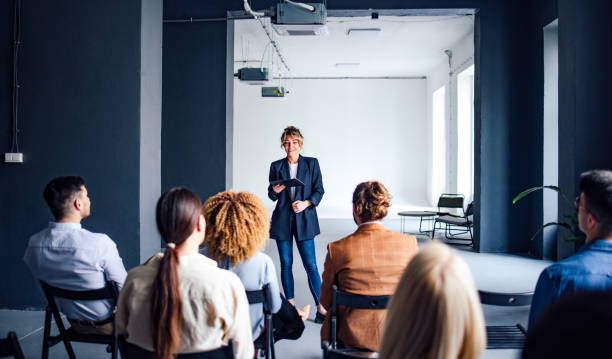 istock Cheerful Female Presenter Interacting With the Audience 1408304051