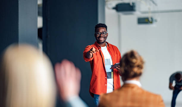 istock Cheerful Male Presenter Interacting With the Audience 1408304054